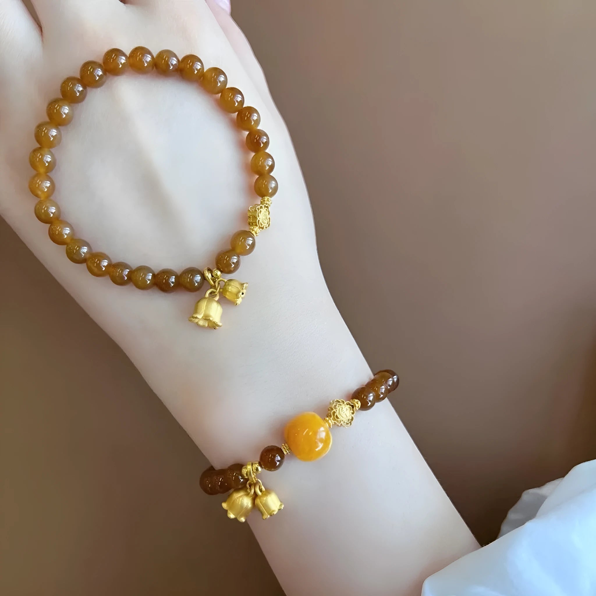 Caramel-coloured women's bracelet with electroplated beeswax finish and lily flower design.