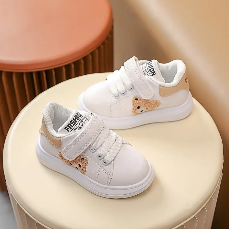 Baby Bear cartoon pattern children's sneakers in green, shown on a white background.