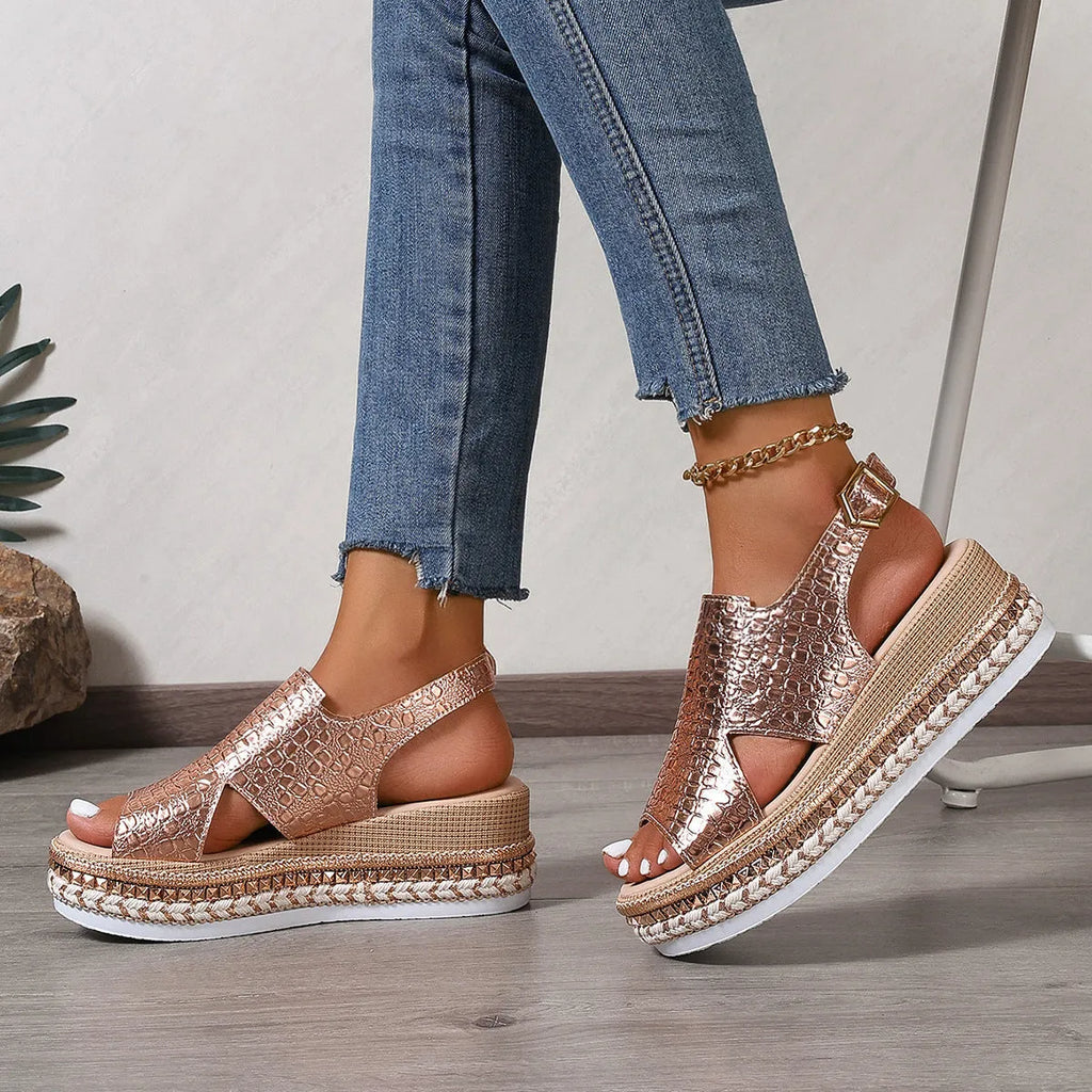 Gold women's Roman sandals with round hollow-out toe and an ankle buckle strap on a rubber sole.
