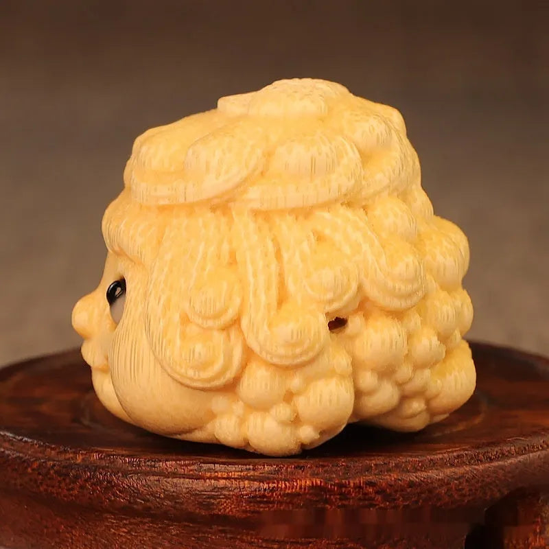 Solid bamboo carving of a cute golden toad princess ornament, 5 cm tall, on a plain background.