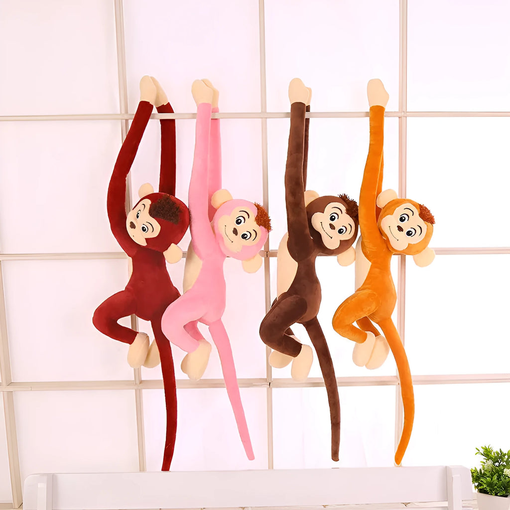 Long-arm pink plush monkey toy hanging from a curtain as home decoration.