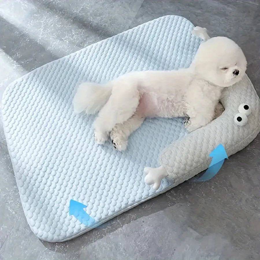 Blue pet bed cushion with big-eyed monster design for dogs and cats on a wooden floor