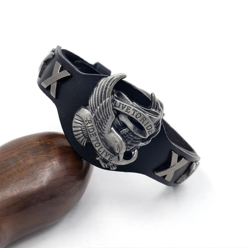 Black leather bracelet with a geometric alloy eagle watch-buttom centrepiece.