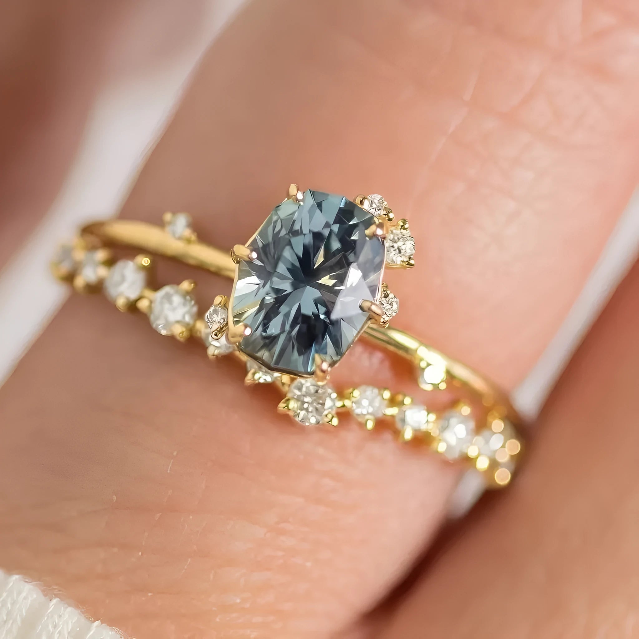 Gold plated women's flower-shaped ring with a green zircon stone, shown in a pair.