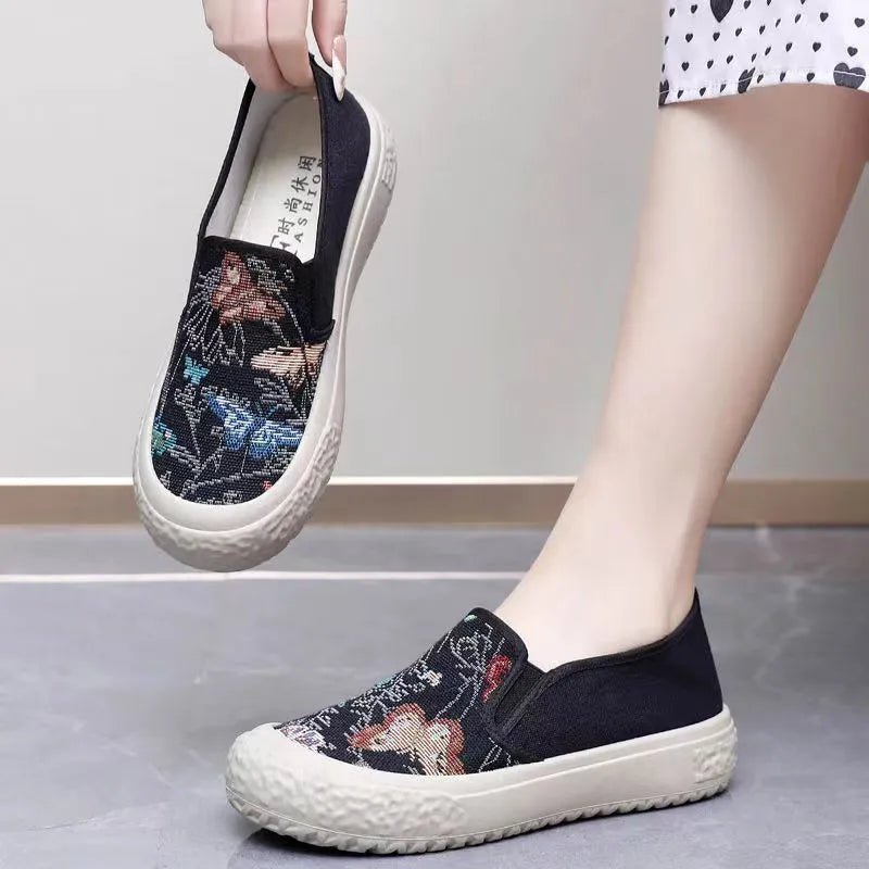Women's slip-on canvas shoes in Black with round toe and decorative sewing thread details