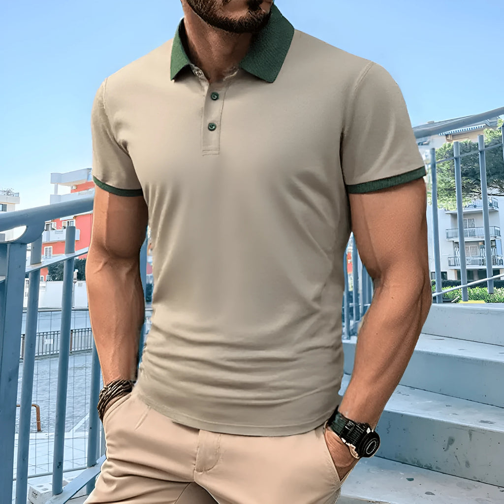 A green ice silk polo shirt with short sleeves and a flocked design on the front, laid flat.