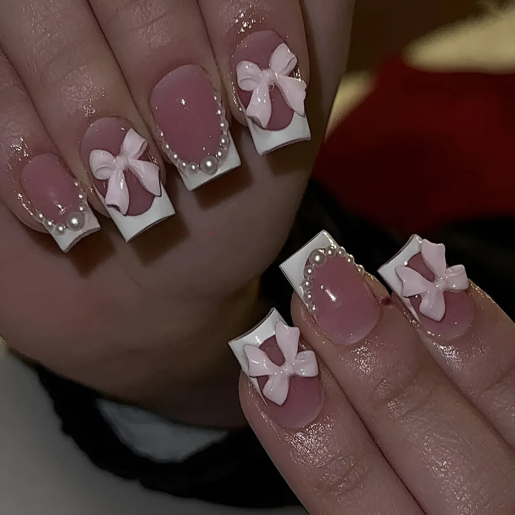 Short white French style press-on nails with bow, tulip, and leopard print designs.