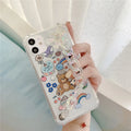 Clear TPU iPhone case with an attached bear chain and cartoon pendant charm