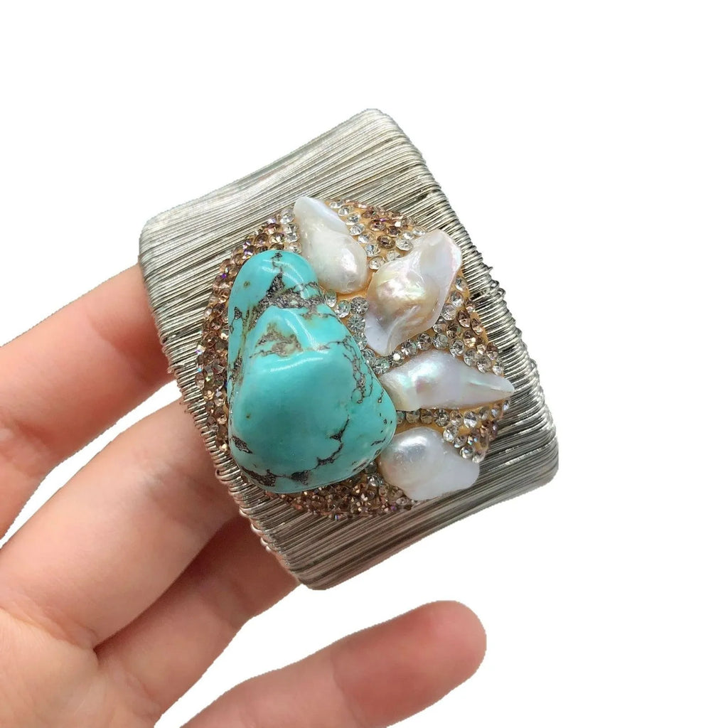 Silver coloured women's bracelet with pearl material and diamond inlay in original baroque design