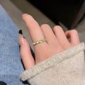 Geometric bow adjustable open ring in copper with electroplated gold finish on finger