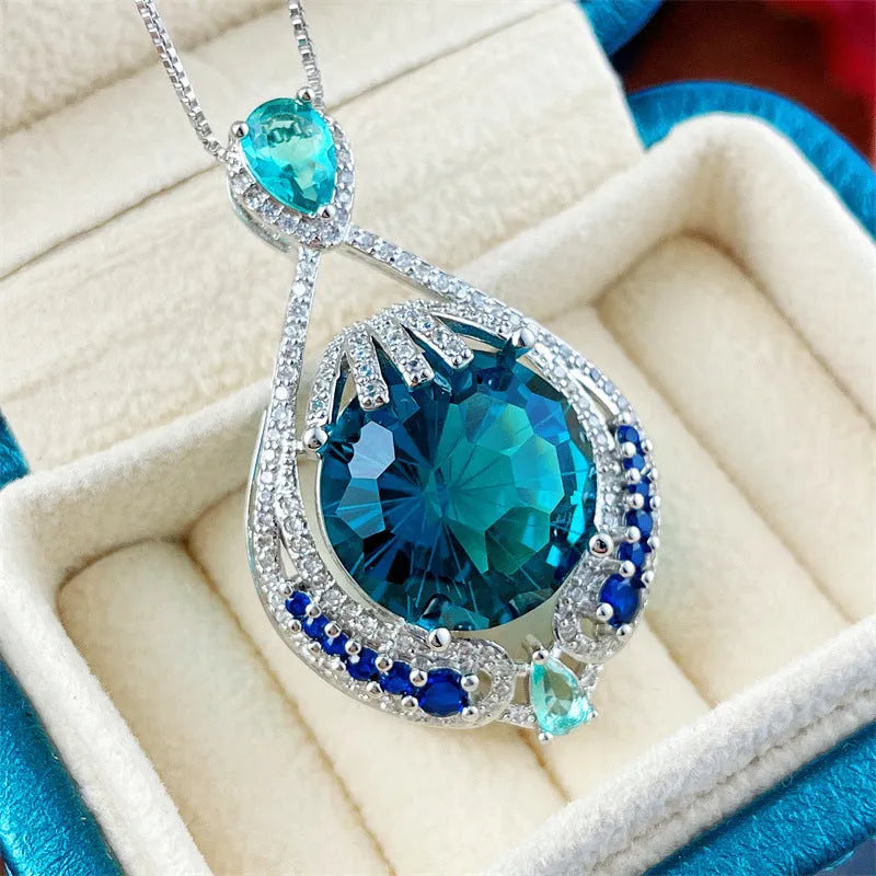 Blue geometric necklace with fireworks-cut crystal pendant on water wave chain