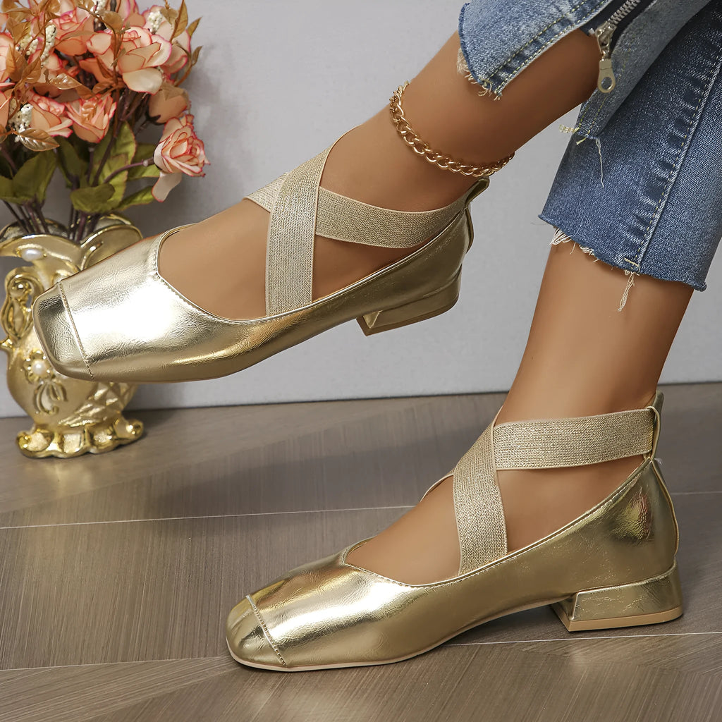 Gold French evening style slip-on pumps with a skirted collar and square toe on a white background.