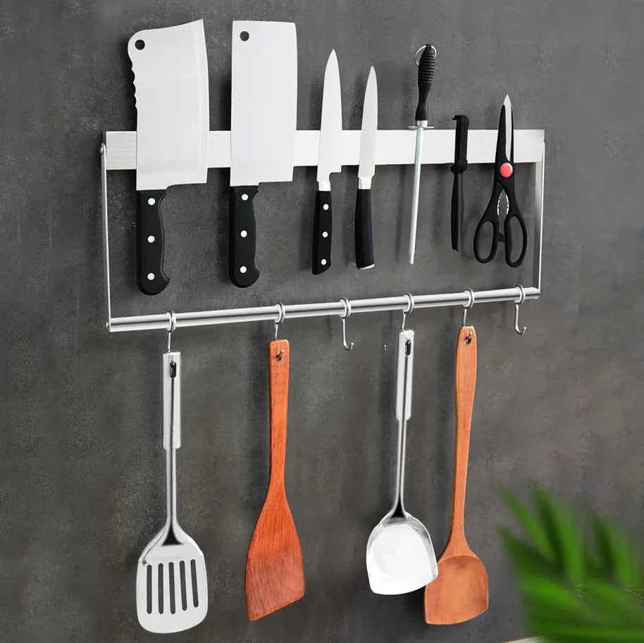 Stainless steel wall-mounted magnetic knife storage rack in various lengths on a kitchen wall.