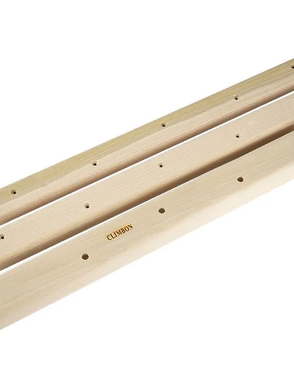 Set of three solid wooden grip strength training hangboards in different sizes on a grey background.