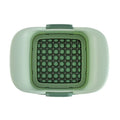 Green multifunctional vegetable chopper with stainless steel blades for dicing onions and slicing cucumbers.