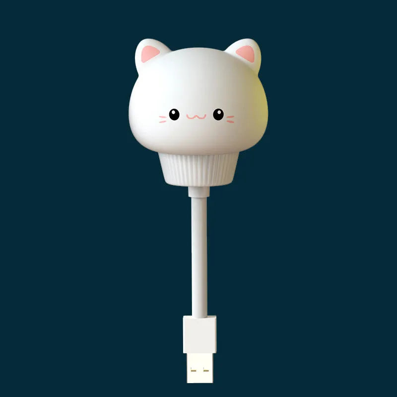 Cute cartoon animal USB night light in bear shape with soft white glow on a bedside table.