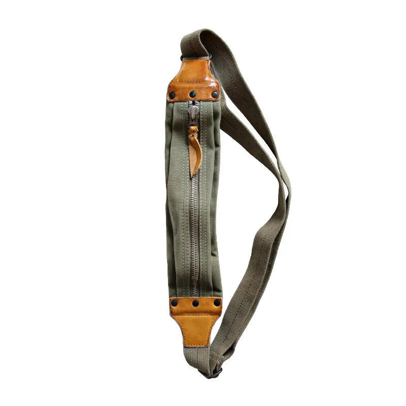 Green retro military style chest bag made of canvas with leather accents.