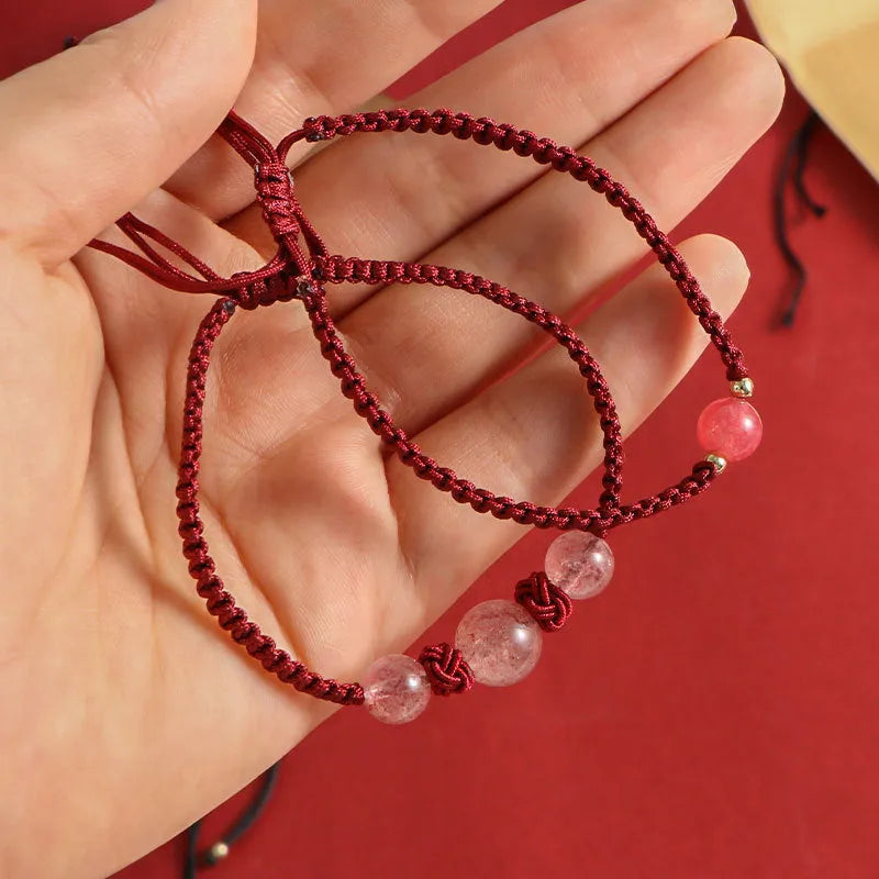 Woven rope bracelet with spherical strawberry quartz beads and alloy accents