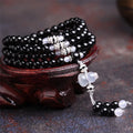 Natural black agate bracelet with 108 beads showing geometric shapes and numeric design elements
