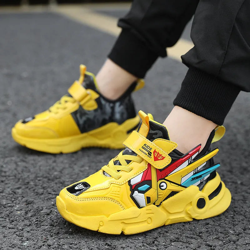 Boy's yellow artificial leather running shoes with Velcro strap and cartoon pattern, shown on a rubber sole.