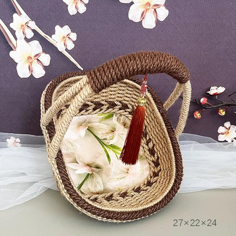 Small hand-woven straw storage basket in brown, measuring 19cm wide.