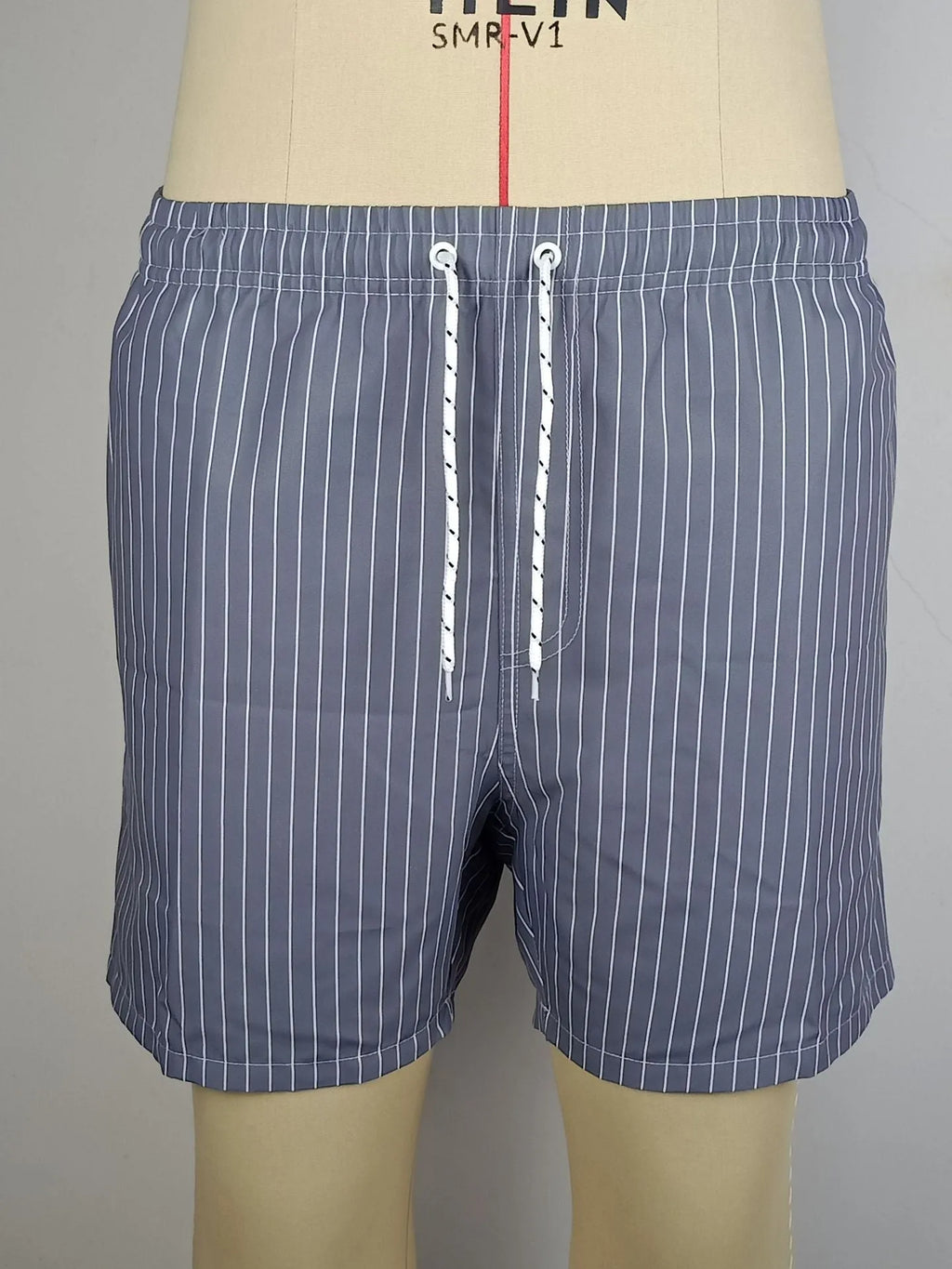 Polyester fibre striped beach shorts with straight leg openings and triangle lining in multiple colours
