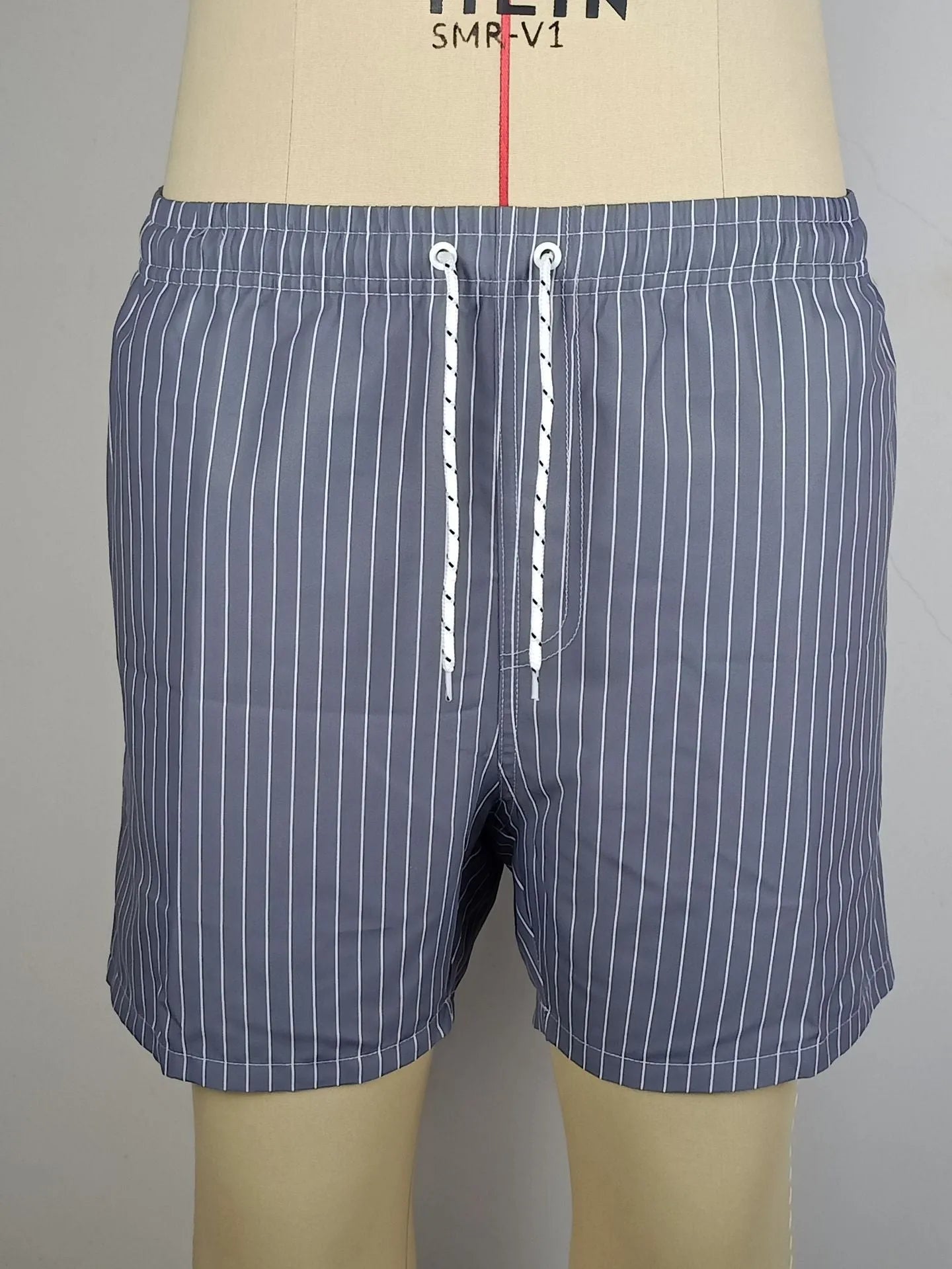 Polyester fibre striped beach shorts with straight leg openings and triangle lining in multiple colours