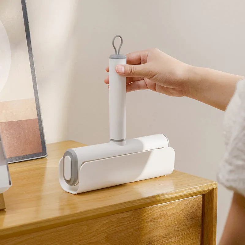 Long-handle lint roller with removable adhesive head for picking up pet hair from floors and furniture