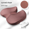 Curved bevel design seat cushion for tailbone support in beige colour on a chair