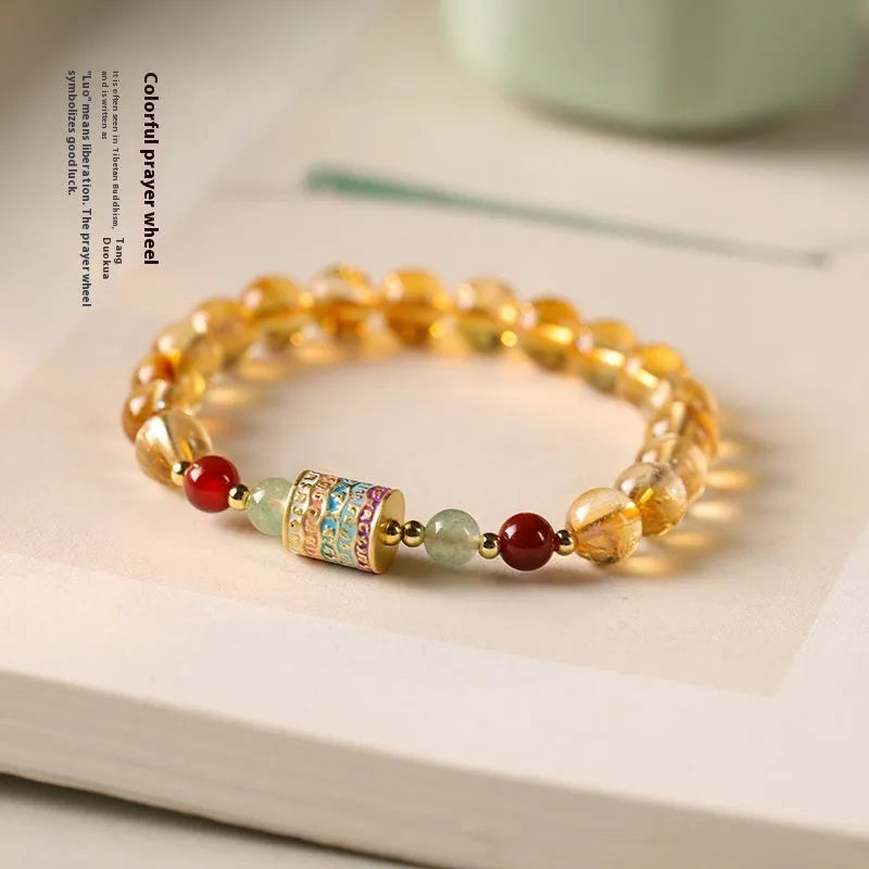 Yellow citrine bracelet with prayer wheel elements on 8mm round beads
