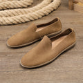 Handmade low top men's shoes in khaki or grey with a flat wedge heel and rubber sole.