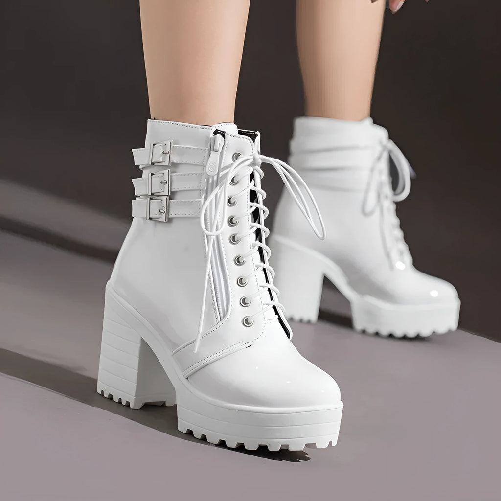 Women's black thick-heeled short boots with lace-up front and round toe on a rubber sole.
