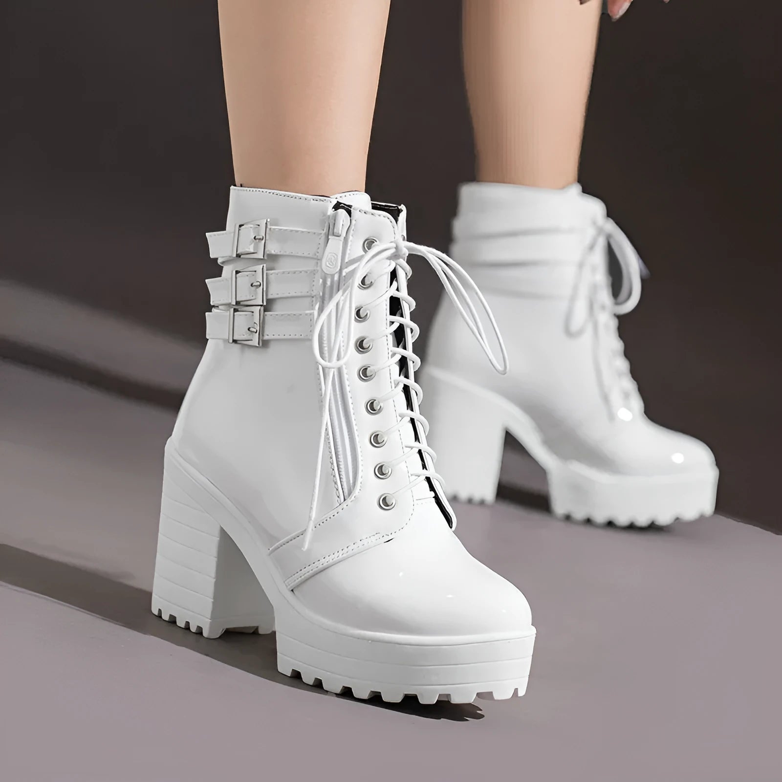 Women's black thick-heeled short boots with lace-up front and round toe on a rubber sole.