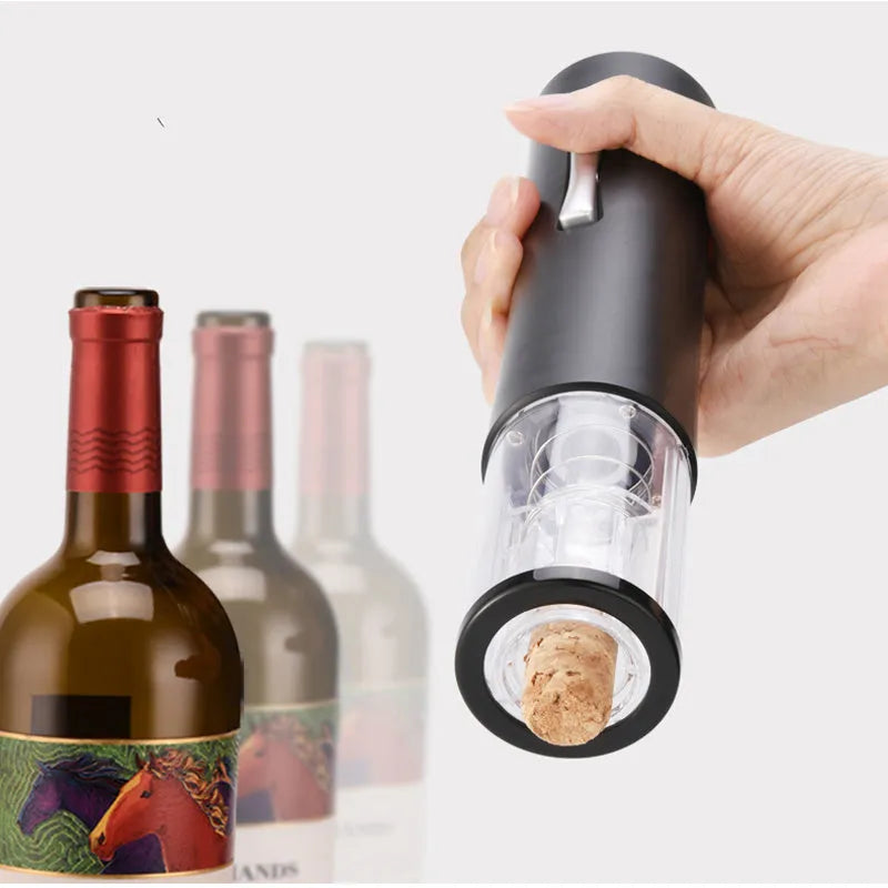 Automatic electric wine opener with black ABS shell and foil cutter set on a table alongside a wine bottle