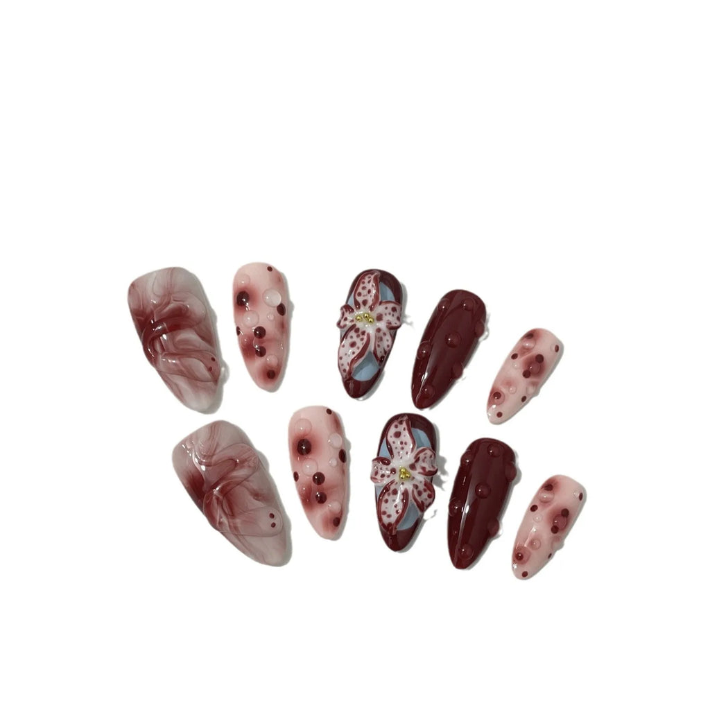 Hand-painted 3D floral artificial press-on nails in almond colour with cat's eye finish.