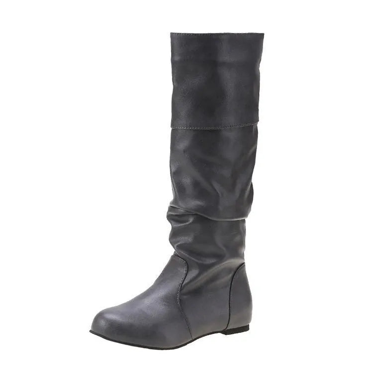 Women's black slip-on flat boots with round toe and high cylinder shaft on a non-slip rubber sole.