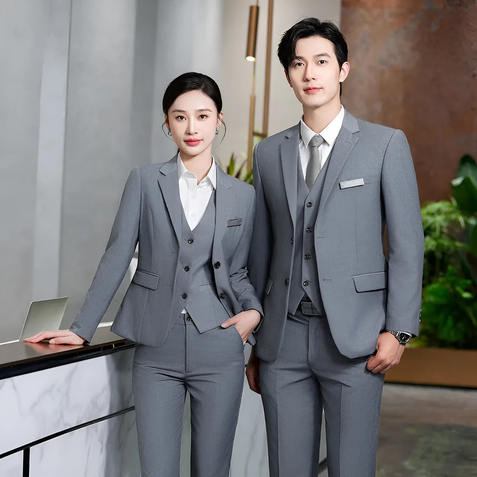 Men's and women's work suit with long sleeve polyester jacket and matching trousers or skirt in black