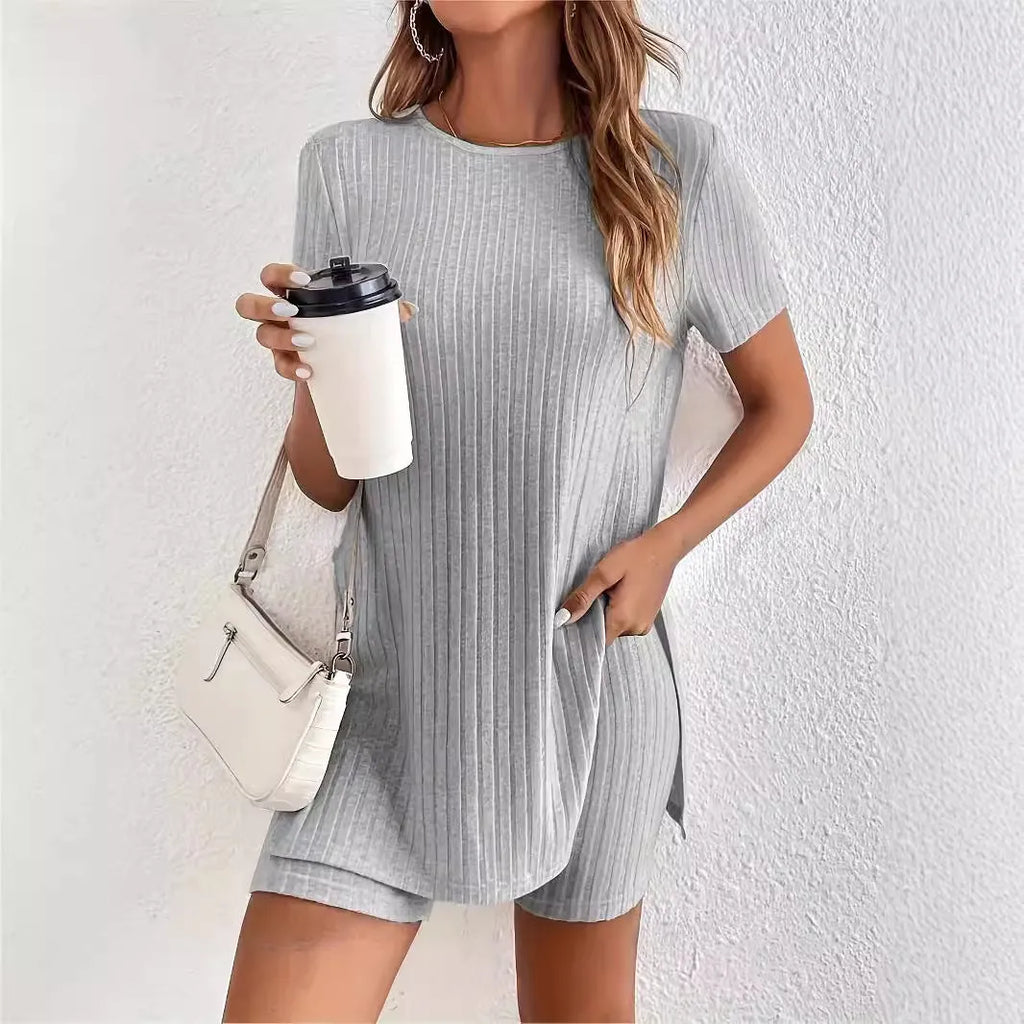Women's black ribbed cotton shorts suit with crew neck top and matching shorts on a hanger.