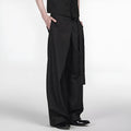 Black straight leg trousers with a single front pleat and an adjustable waistband on a hanger.