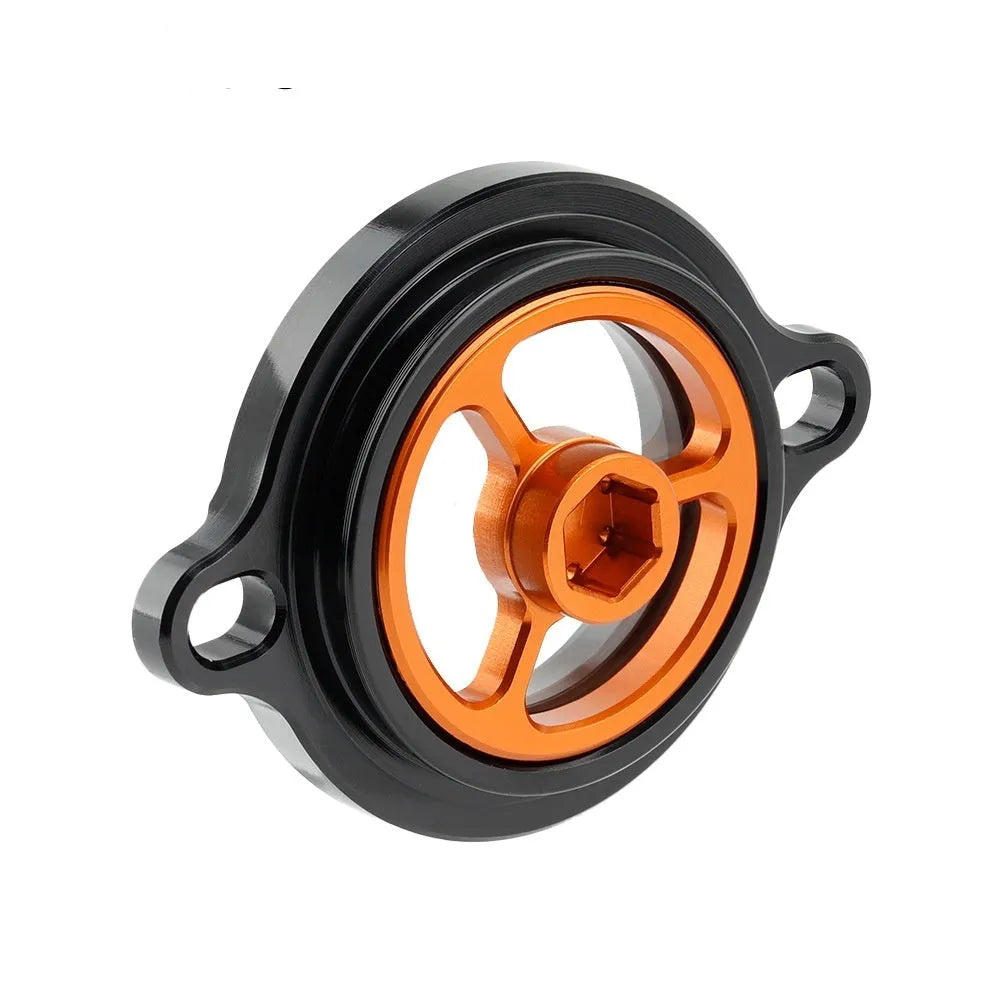 Aluminium alloy transparent oil filter cover for KTM DUKE motorcycles on a workbench
