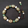 Green agate Tibetan bracelet with three-eye geometric bead pattern and adjustable cord closure