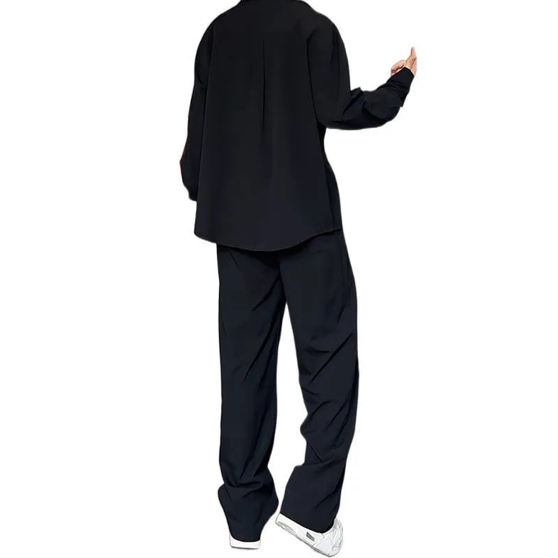 Men's black casual two-piece suit with long sleeve polo shirt and trousers on a hanger