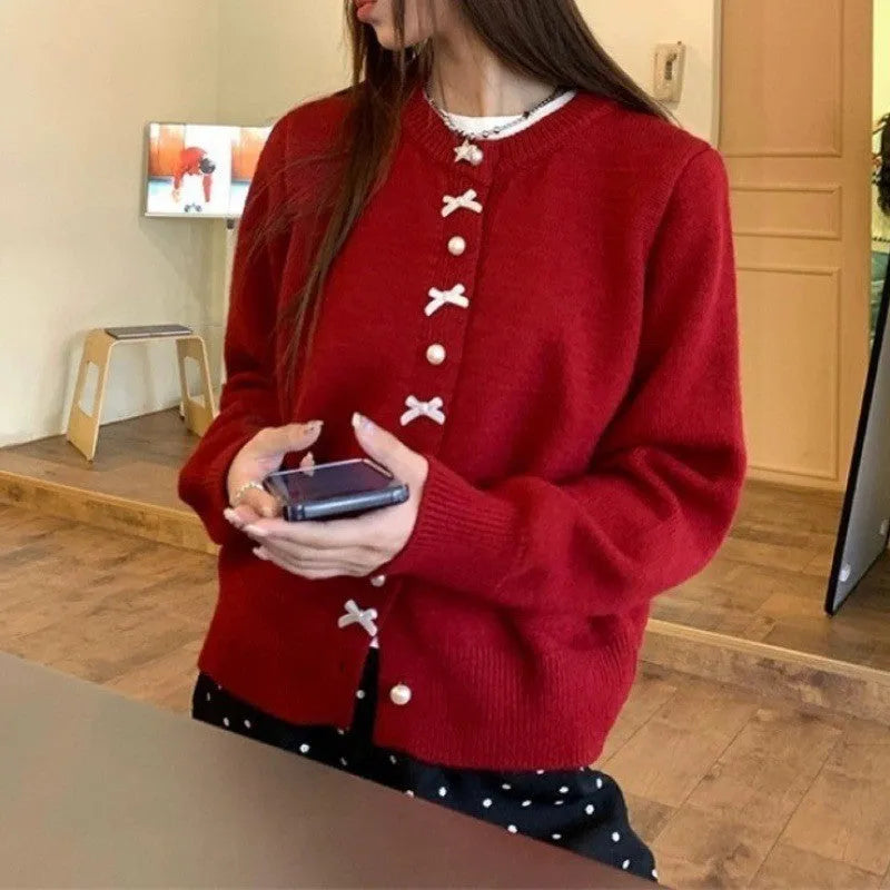 Women's solid colour cardigan sweater with bow and pearl buttons, shown in light yellow.