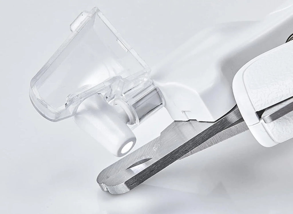 White pet nail clipper with LED light and transparent anti-splash guard on a blue background.