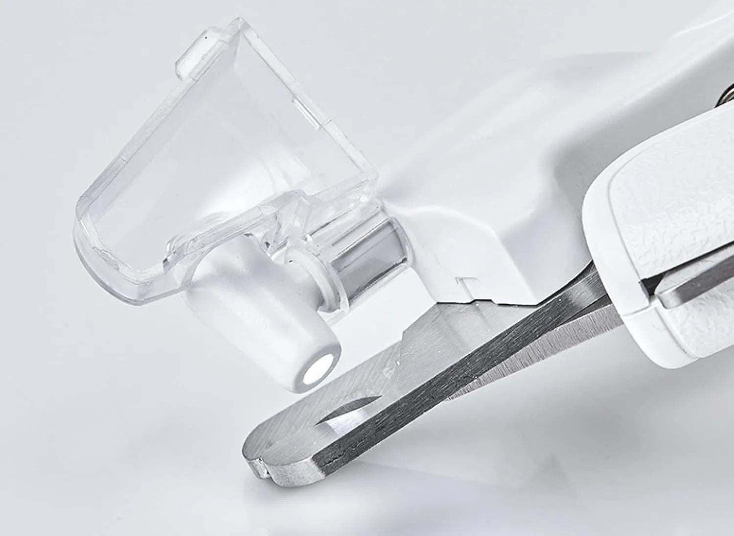 White pet nail clipper with LED light and transparent anti-splash guard on a blue background.