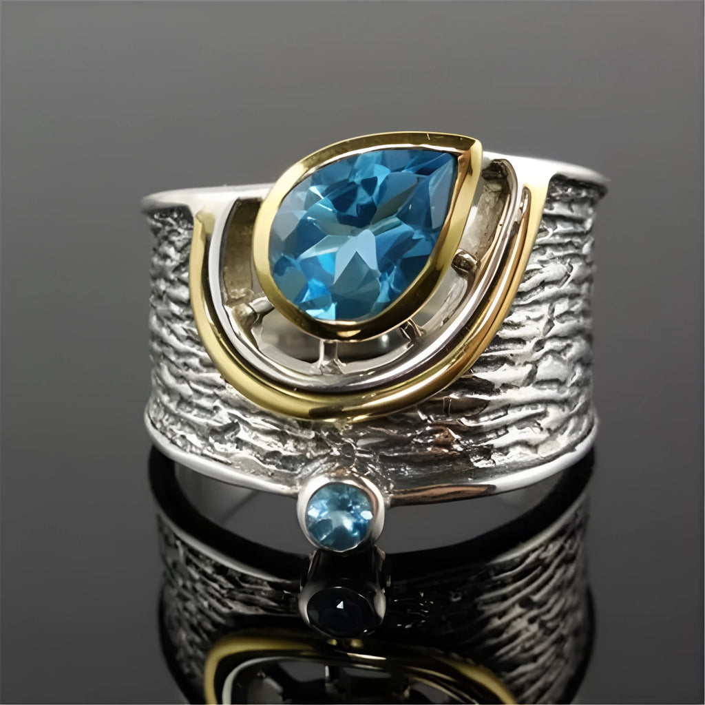 Close-up of a women's blue zircon rhinestone ring in a creative Chinese style drop shape design.