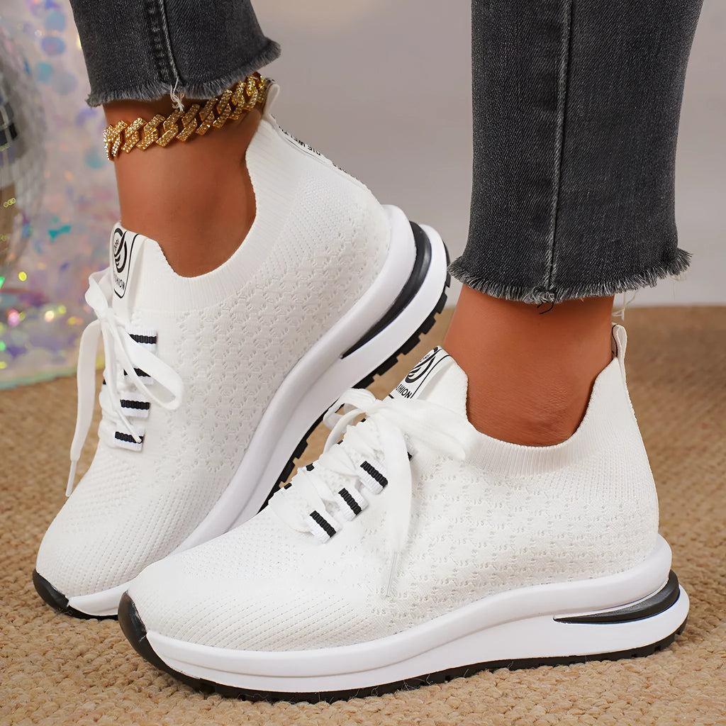 Women's black mesh lace-up sneakers with flat rubber sole and round toe