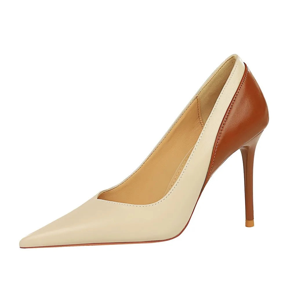 Retro black and creamy-white women's stiletto heels with pointed toe and high thin heel for banquet events.