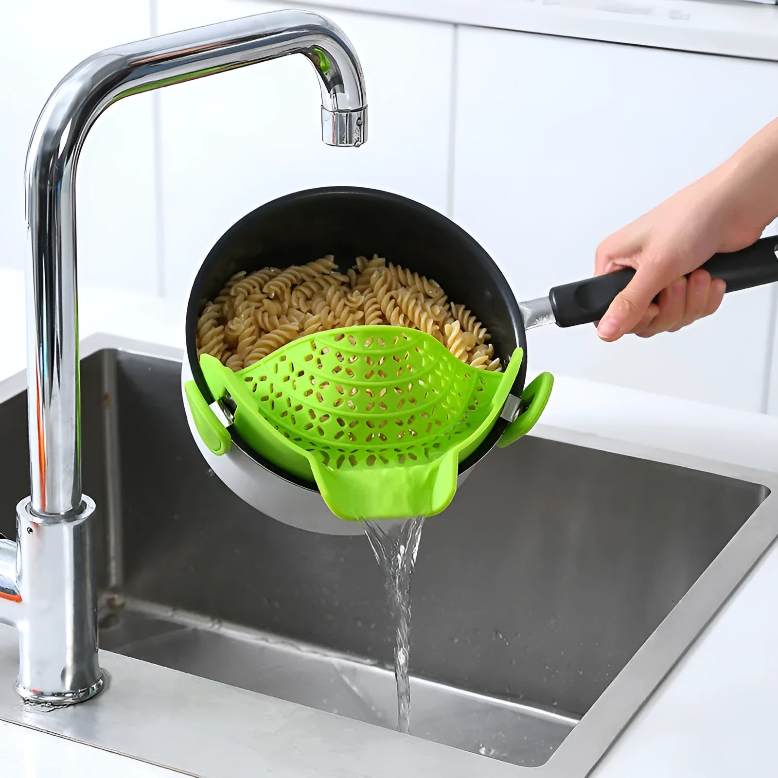 Silicone and stainless steel pot side drain stopper in multiple colours on a kitchen counter.