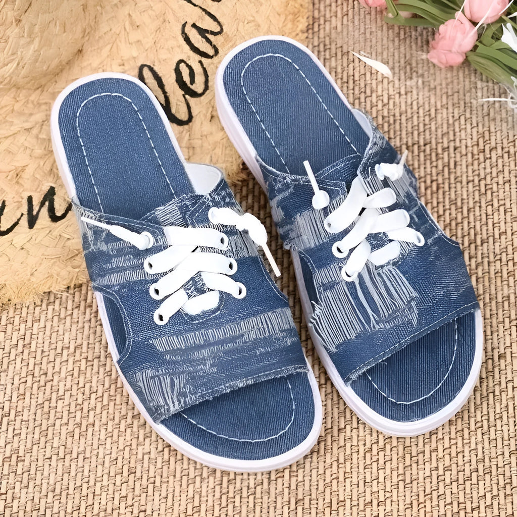 Blue women's Roman-style flat canvas slippers with a cloth upper and rubber sole.